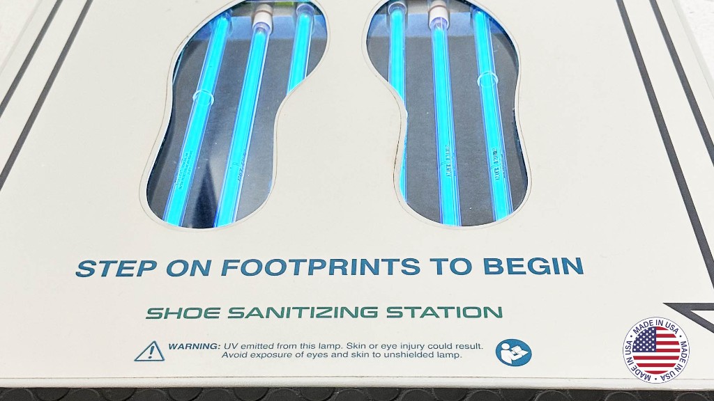 Close-up of UVZone footprint windows with UV-C lamps active and step-on instructions on the station surface